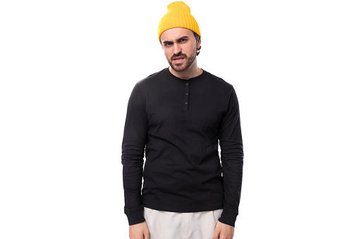 portrait of a young 30s authentic brunette male adult in a black sweater on a white background with copy space.