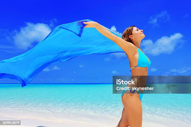 Happy Woman Walking On A Beach With Long Sarong Stock Photo - Download Image Now - Activity, Adult, Adults Only