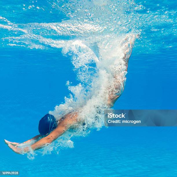 Swimmer Diving Into A Clear Blue Pool Stock Photo - Download Image Now - Diving Into Water, Swimming Pool, Jumping