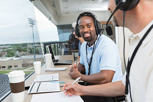 istock Sports commentators and other media covering game in press box 169944046