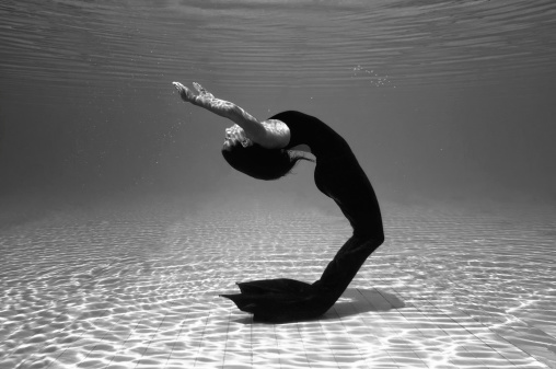 Black mermaid playing underwater