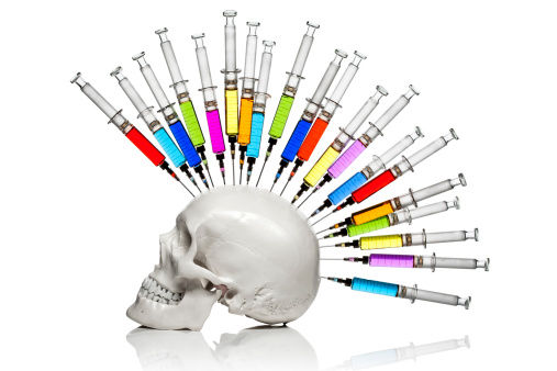 Conceptual photography of ink filled syringes inserted into a skull. As is - some clean up only. AdobeRGB color space.