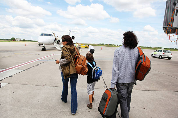 istock Travelers Walking Toward Airplane 169945036