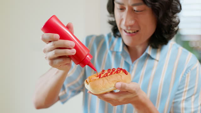 man eat hot dog