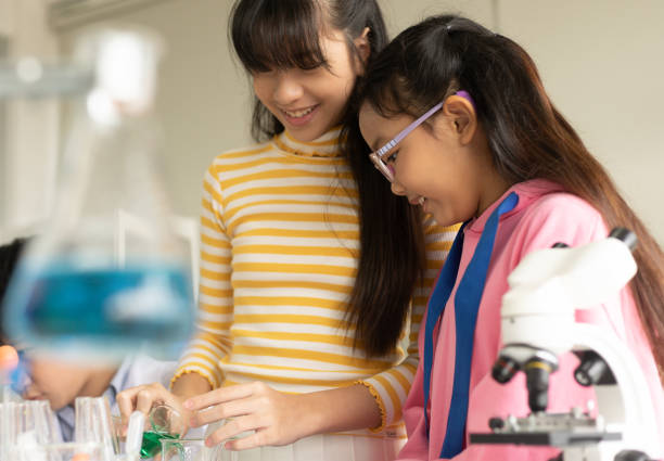 istock Children scientist doing science experiment test with chemistry in a laboratory. STEM - education and innovation professional concept. 1699458819