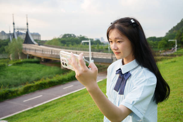 istock woman taking photo 1699494632