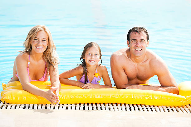istock Smiling family enjoying in the pool. 169949734