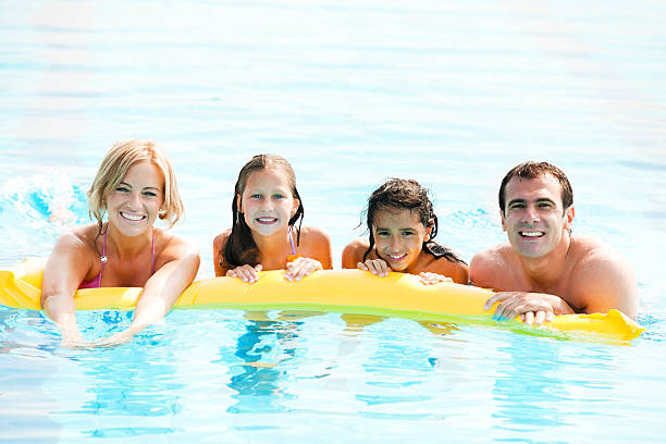 istock Smiling family enjoying in the pool. 169949760