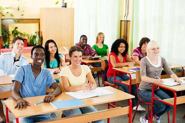 istock Group of teenagers students sitting in classroom. 169949805