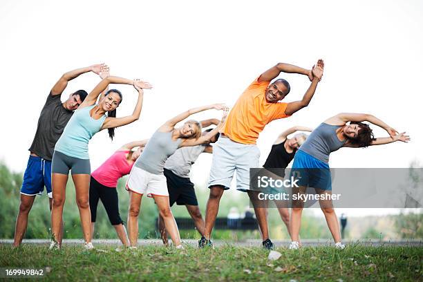 Group Of People Doing Stretching Exercises Stock Photo - Download Image Now - Aerobics, Group Of People, Multiracial Group