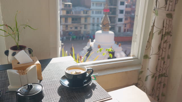 Cup of tea with the view on white stupa in Kathmandu