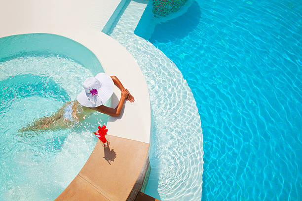 frau entspannung in einem whirlpool im freien - drink swimming pool cocktail poolside stock-fotos und bilder