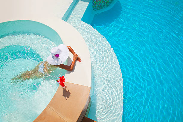 женщина расслабиться в джакузи на открытом воздухе - swimwear bikini swimming pool red стоковые фото и изображения