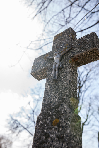 Crucifix on the old gravestone on the Old catholic cemetery, Belarus, Eastern Europe
