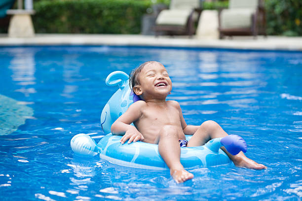 Child 2 years old enjoying in swimming pool