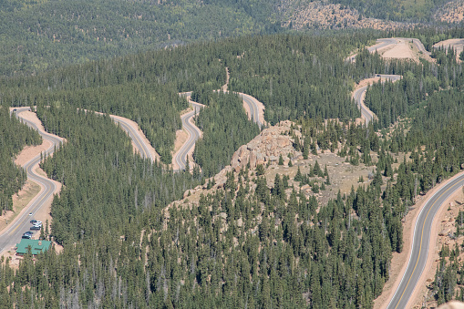 Curves and big drop-offs of the Steep Pikes Peak highway to the summit of America's Mountain (elevation 14115 feet) in the Rocky Mountains in central Colorado in western USA of North America. Nearby cities are Colorado Springs, Denver and Pueblo, Colorado.