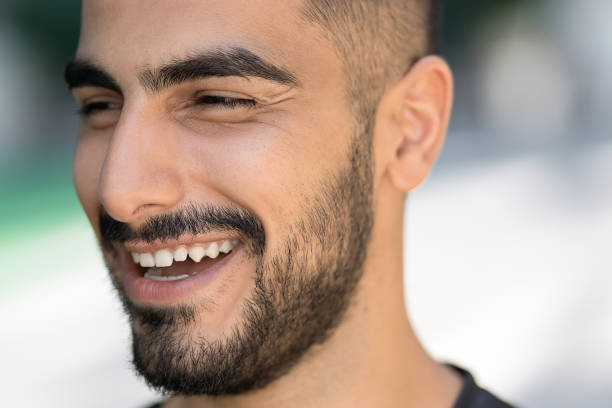 istock Happy confident middle eastern man laughing and looking away on the street, selective focus 1699518950