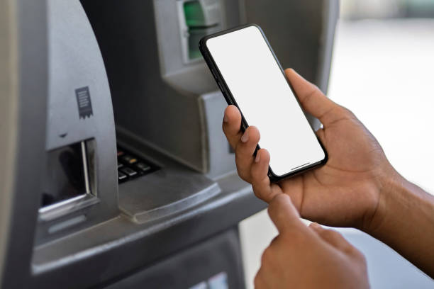 istock Man hand using mobile phone at gas pump station to pay for gasoline 1699518955