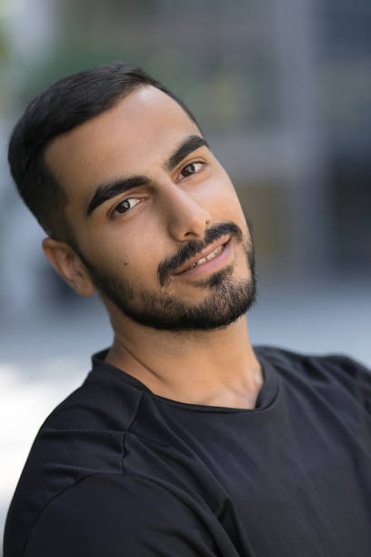 istock Smiling confident middle eastern man looking at camera on the street 1699518959