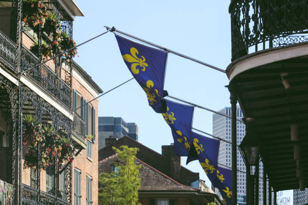 Flags of New Orleans hanging over balcony Row of New Orleans flags hanging over balcony in downtown new orleans fleur de lis stock pictures, royalty-free photos & images