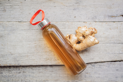 Ginger Ale - Homemade lemon and ginger organic probiotic drink or Kombucha, copy space.