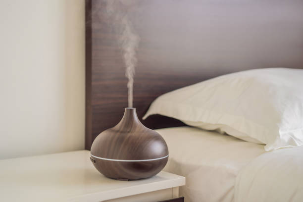 istock Aromatherapy Concept. Wooden Electric Ultrasonic Essential Oil Aroma Diffuser and Humidifier. Ultrasonic aroma diffuser for home 1699536092