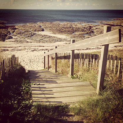 A sunny summer day at a wooden beach staircase on the rocky coastline near Sarzeau, Brittany, France. Shot with an iPhone 5, processed with Instagram