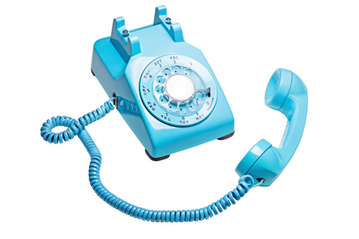 Photo of a blue retro rotary telephone with the receiver off the hook.