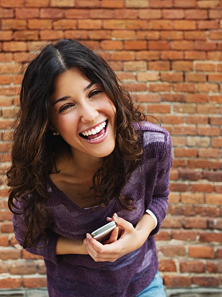 istock Young woman with phone smiling 169956219