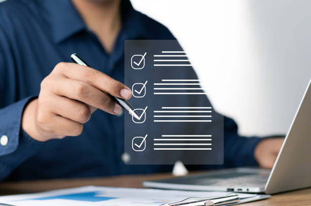 istock Digital Checklists for efficient business management, Businessman touching marking on checklist guide to paperless assessment and Future Success, Streamlining operations with online surveys. 1699562741