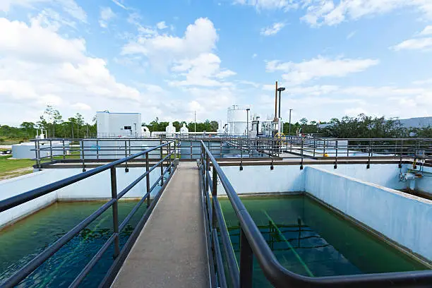 A bridge-way over one of the holding tanks at a public county municipal water plant.