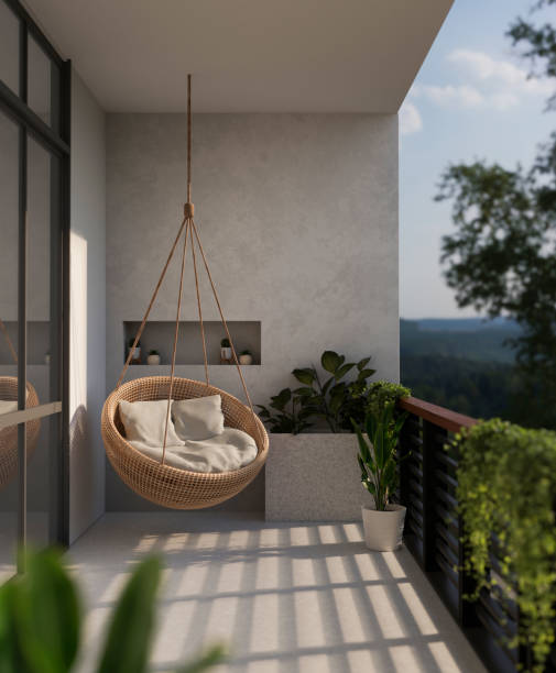 un moderno balcone di casa bella con una poltrona in vimini sospesa e una splendida vista sulla natura. - balcone foto e immagini stock