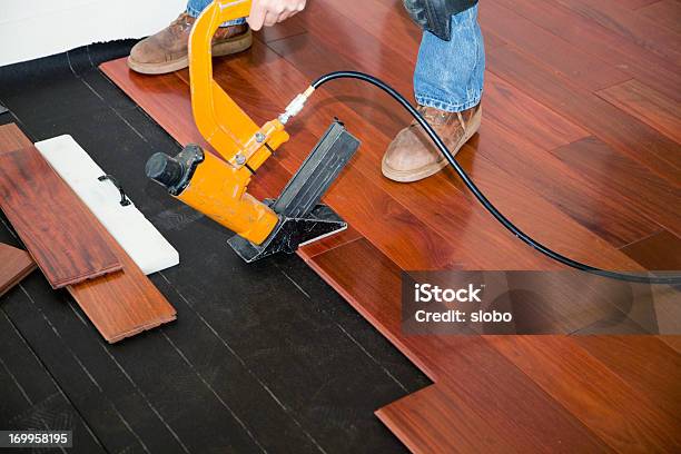 Installing Hardwood Floor Stock Photo - Download Image Now - Flooring, Hardwood, Blue-collar Worker