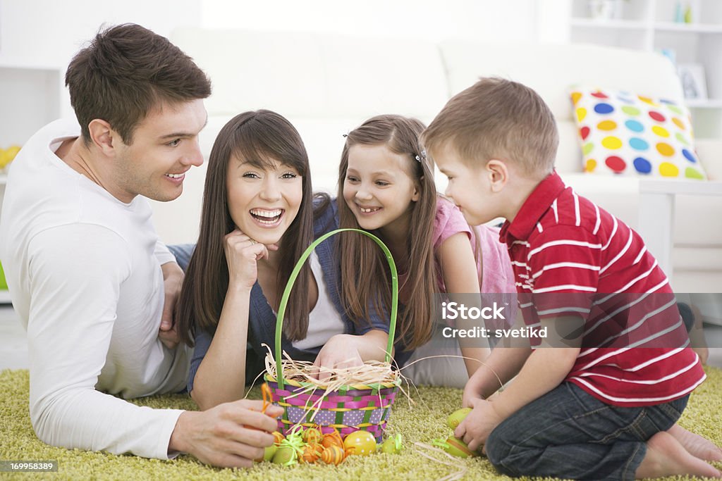 Easter fun. Smiling family having fun with easter eggs indoors. 2-3 Years Stock Photo