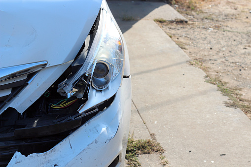 Broken car headlights after an accident. Photo close-up.