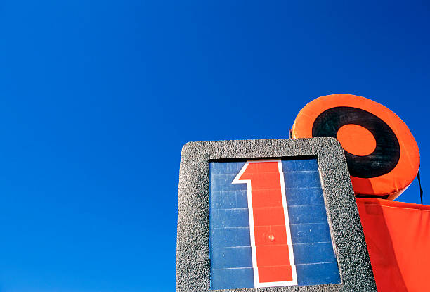 Looking up at the First Down marker against a clear blue sky