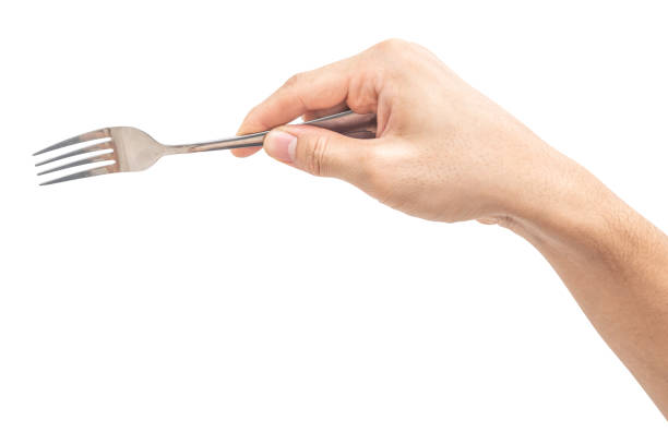 istock isolated of a man's hand holding a silver steel fork. 1699608332