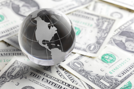 glass globe and money ( usa dollar) close up