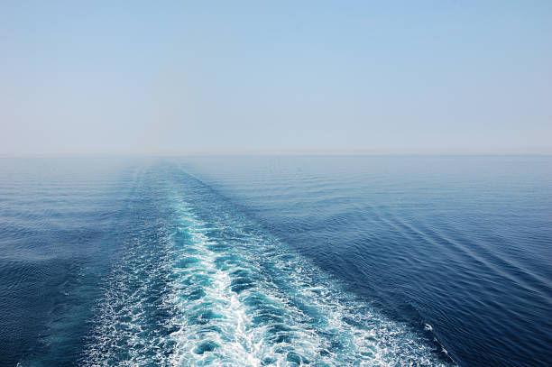 Boat Wake The wake of a cruise ship on a hazy day in the Mediterranean Sea. sea wake stock pictures, royalty-free photos & images