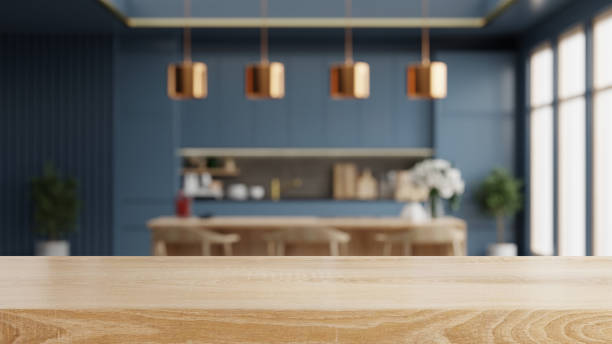 istock Wooden table top on blur kitchen room background,Modern Contemporary blue kitchen room interior. 1699611981
