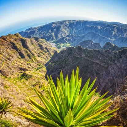 View on the mountain range of Santo Antao (Cape Verde). At the end of the valley the Atlantic ocean. (Stitched Panorama with curved horizon) . 