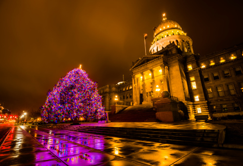 Beautiful Christmas tree decorated with colorful lights in front of Idaho State Capitol building in Boise, Idaho, USA