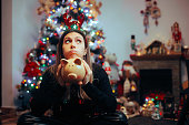 Broke Woman Holding a Piggy Bank Regretting Christmas Spendings