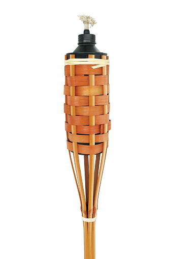 Traditional bamboo torch oil lamp on white background