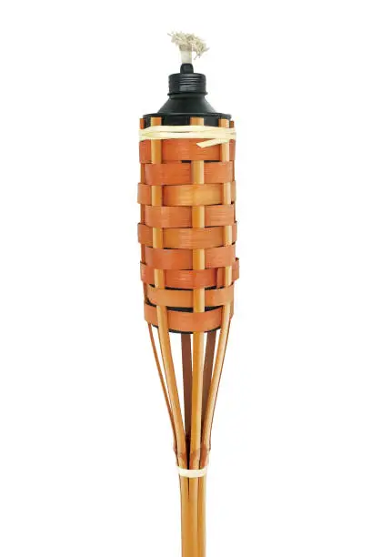 Traditional bamboo torch oil lamp on white background