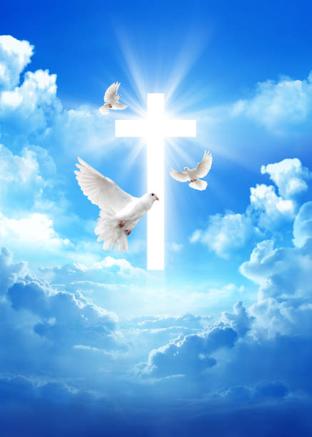 Pirenopolis, Goias, Brazil – June 13, 2021: A cross with an image of the Holy Spirit, with a blue sky in the background.