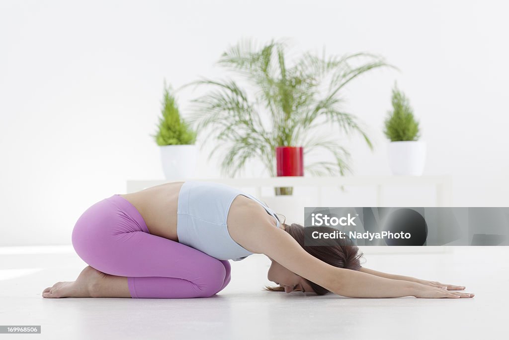 Yoga - Child Pose Woman practicing yoga at home - child pose. Active Lifestyle Stock Photo