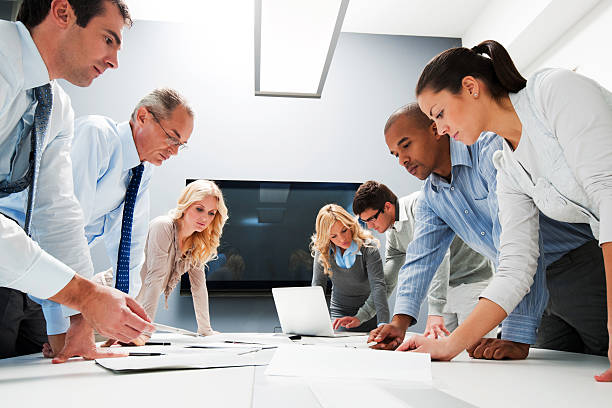 istock Workers at office meeting standing to see reports 169968576