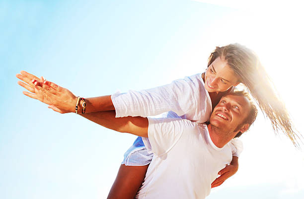 istock Happy young couple having fun at the beach 169968580