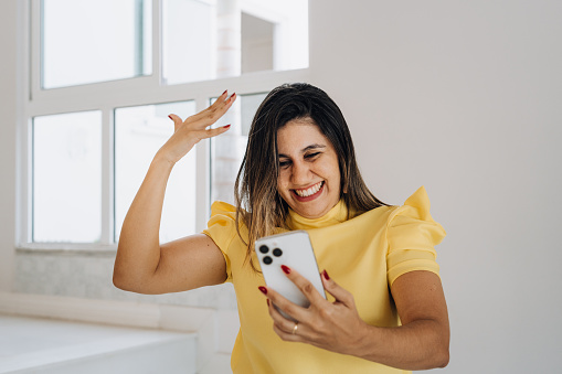 Woman receiving good news on smartphone